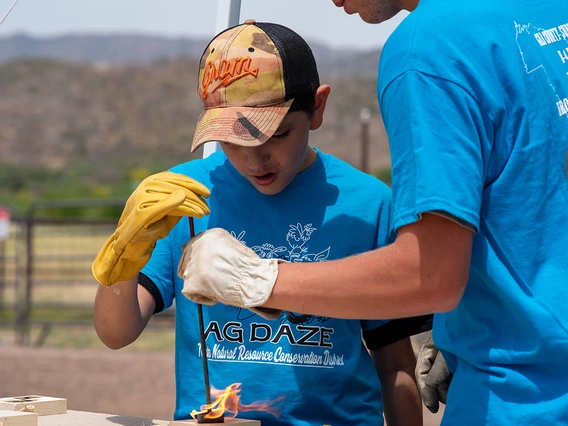 youth burning a design in wood