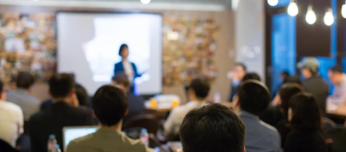 person presenting in fron tof room