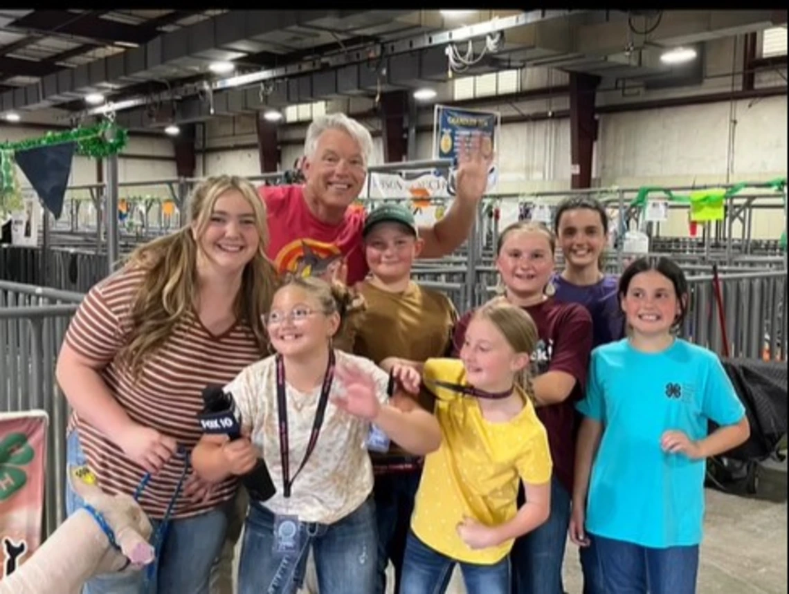 young 4-H kids at fair with volunteer