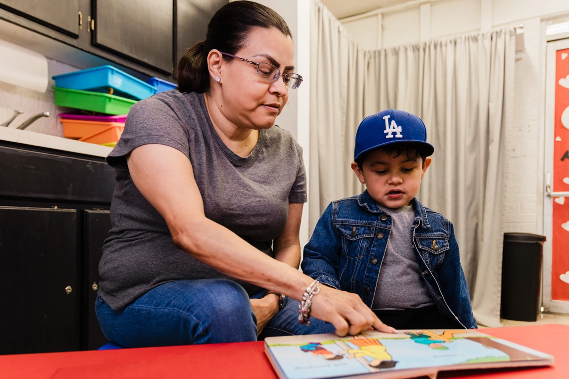 Photo of a woman reading with a toddler