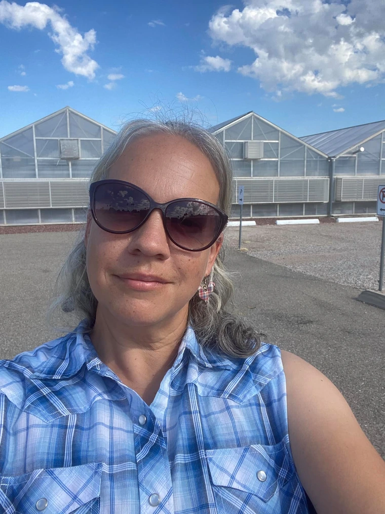 Standing in front of the University of Arizona greenhouses in Tucson
